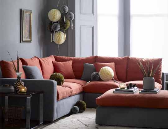 large red corner sofa with footstool